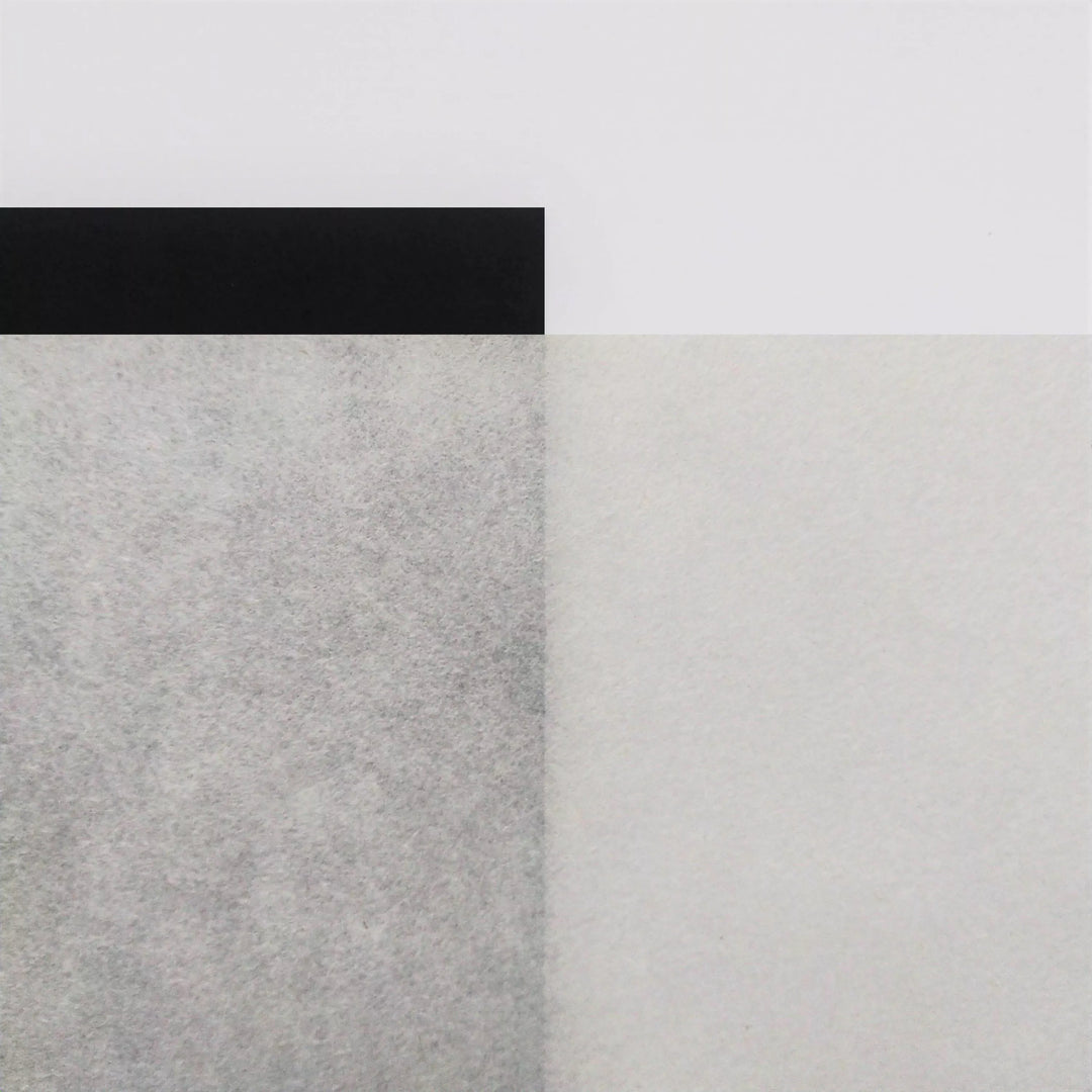 Natural Kozo paper from Kozo Studio with a refined handmade texture, displayed against a white surface to highlight its thin, unbleached mulberry paper finish.