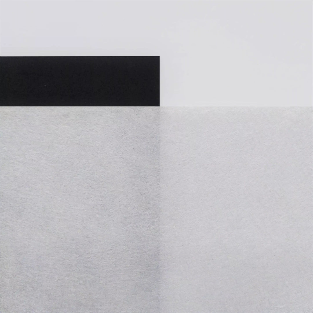 A minimalist design with a black rectangle on an A4 White Kozo Paper (70 gsm) by Kozo Studio. Below, textured rice paper shows a vertical line dividing the lower section for subtle contrast.