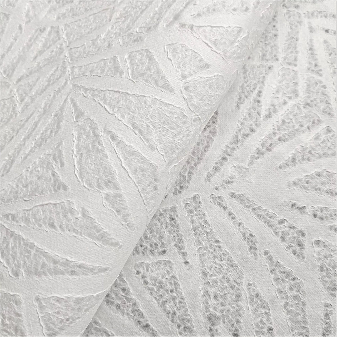 A close-up of textured Handmade Lace Kozo Paper by Kozo Studio, a rice paper with a bamboo leaf pattern.