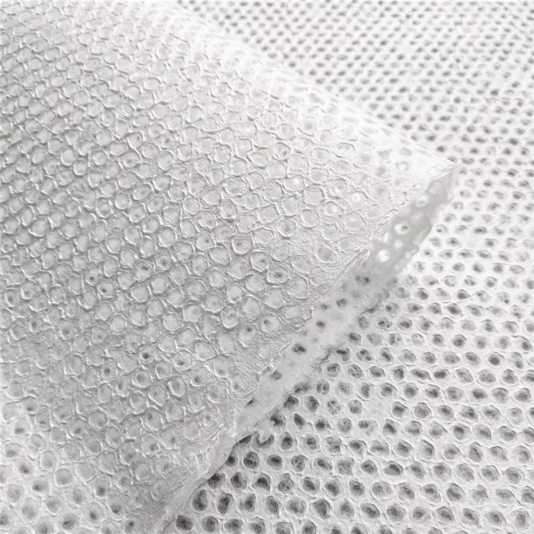 Delicate Mini Dot Handmade Paper Displayed in Natural Light – Kozo Studio mulberry paper shown with translucent lace patterns, perfect for artistic uses like collage, lamps, or custom installations.