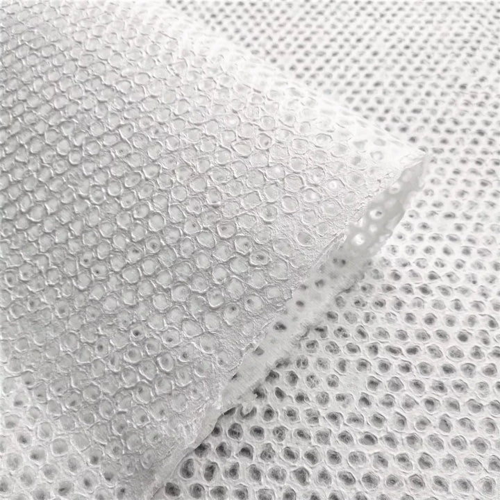 Delicate Mini Dot Handmade Paper Displayed in Natural Light – Kozo Studio mulberry paper shown with translucent lace patterns, perfect for artistic uses like collage, lamps, or custom installations.