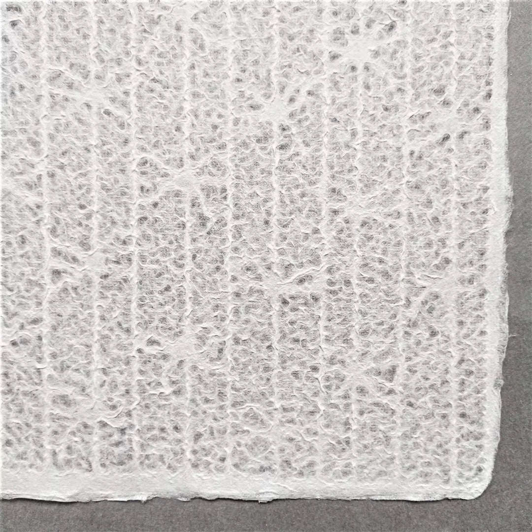 Intricately designed lace-style handmade paper from Kozo Studio using mulberry fibers, showcasing the Rakusui method
