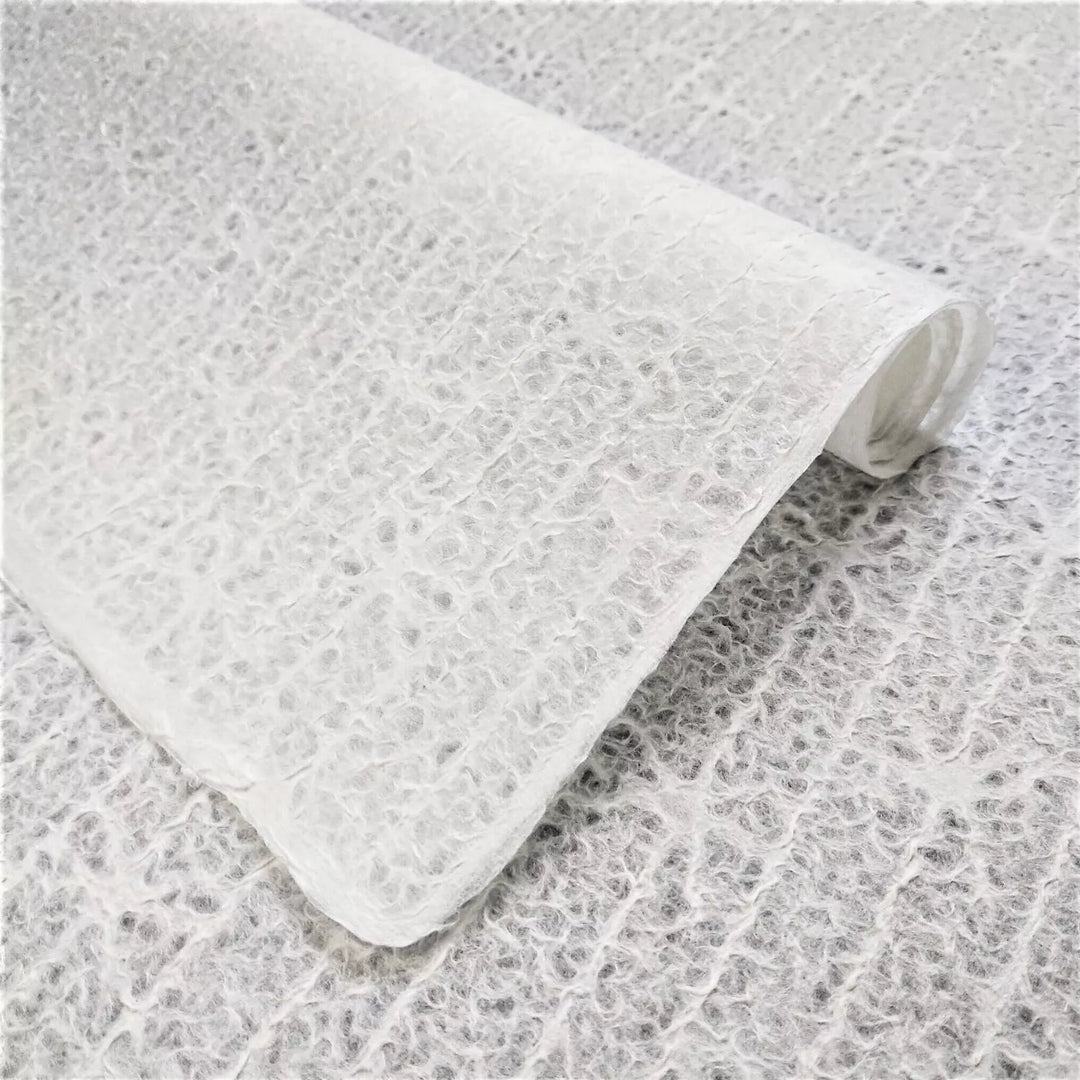 Delicate handmade lace mulberry paper with bow pattern crafted using Rakusui technique at Kozo Studio, ideal for lampshades and window decor