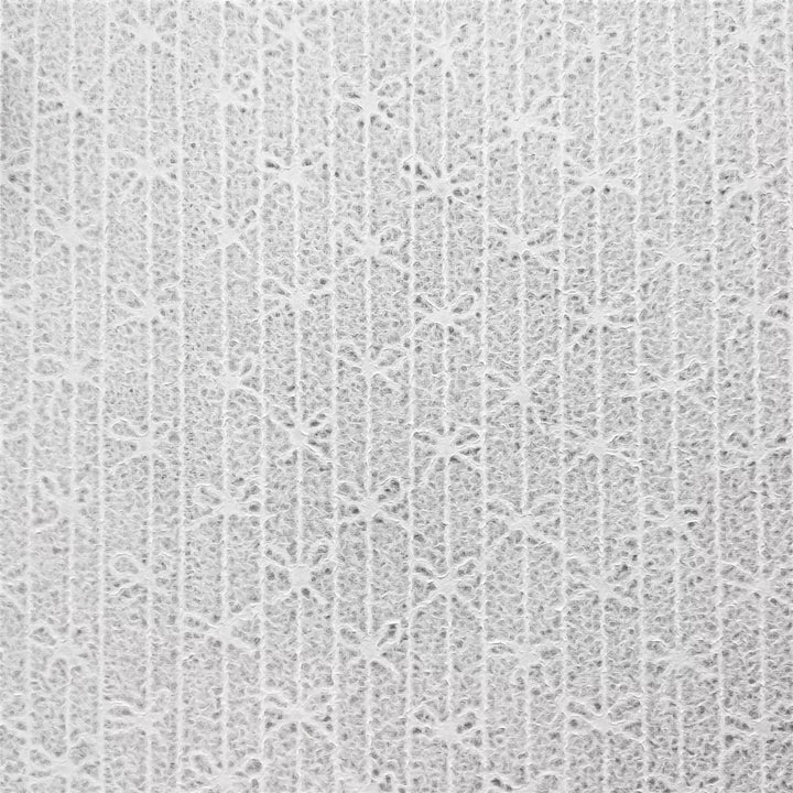Bow-patterned lace handmade paper made from mulberry pulp at Kozo Studio, created with the unique Rakusui water displacement technique