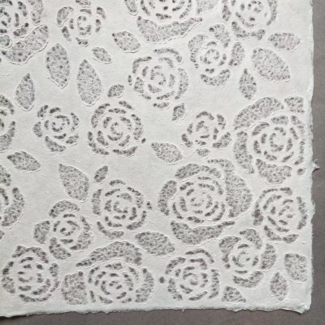 Handmade mulberry paper with lace-style floral designs from Kozo Studio, highlighting its suitability for creative projects and soft interior light diffusion.