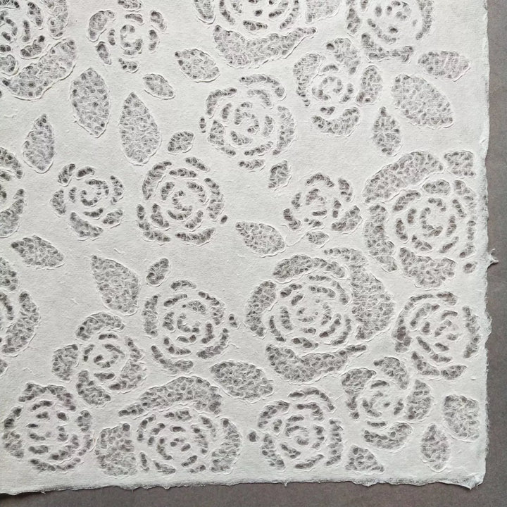 Handmade mulberry paper with lace-style floral designs from Kozo Studio, highlighting its suitability for creative projects and soft interior light diffusion.