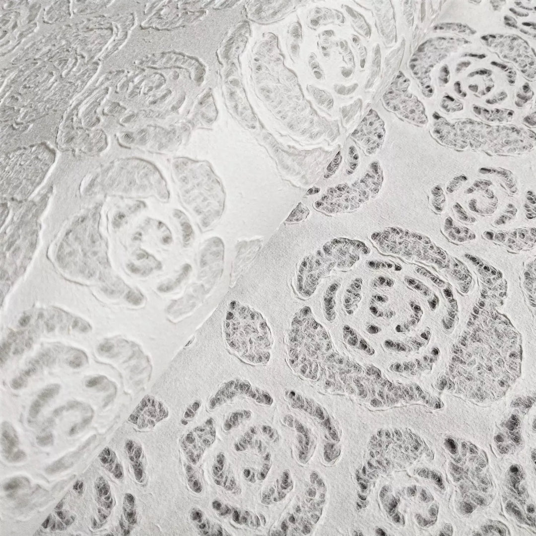 Detailed floral patterns on translucent handmade paper by Kozo Studio, with rose and leaf motifs that highlight fine craftsmanship and artistic versatility.