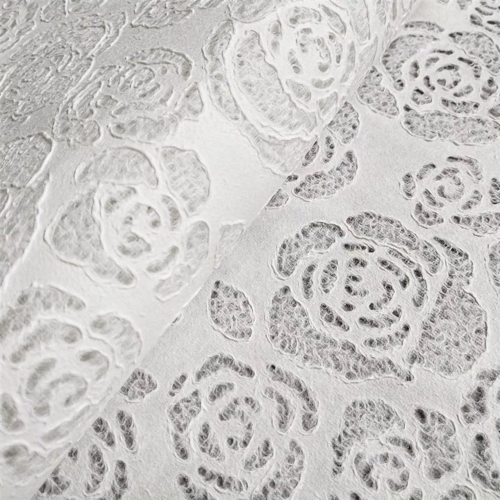 Detailed floral patterns on translucent handmade paper by Kozo Studio, with rose and leaf motifs that highlight fine craftsmanship and artistic versatility.