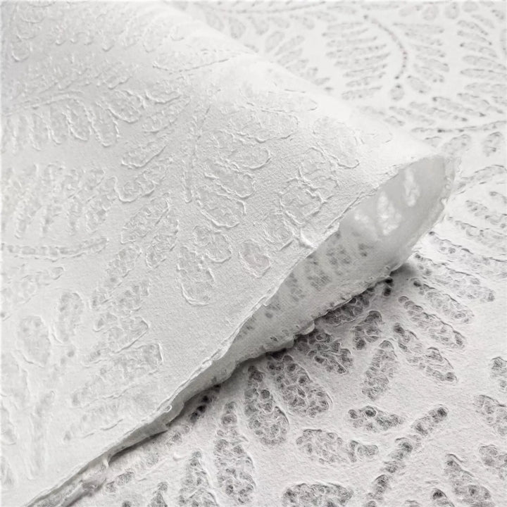 Elegant handmade kozo paper featuring fern-inspired patterns, made with water-displacement on mulberry paper at Kozo Studio for craft versatility.