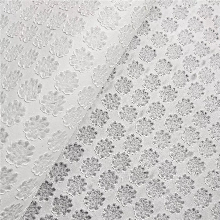 Elegant Handmade Paper by Kozo Studio featuring raised floral textures and lace detailing made from high-quality mulberry paper using traditional methods.