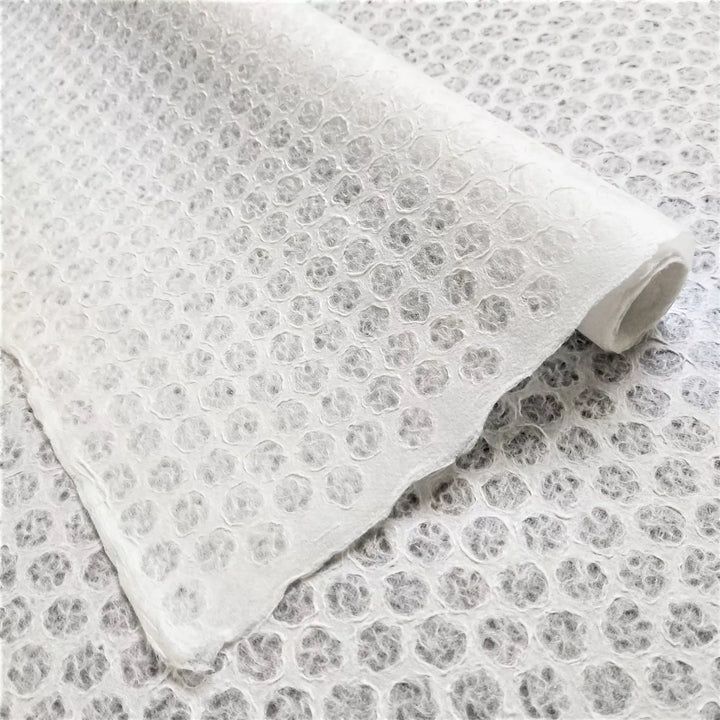 Intricately crafted handmade lace mulberry paper with polkadot pattern, produced using the Rakusui method at Kozo Studio.
