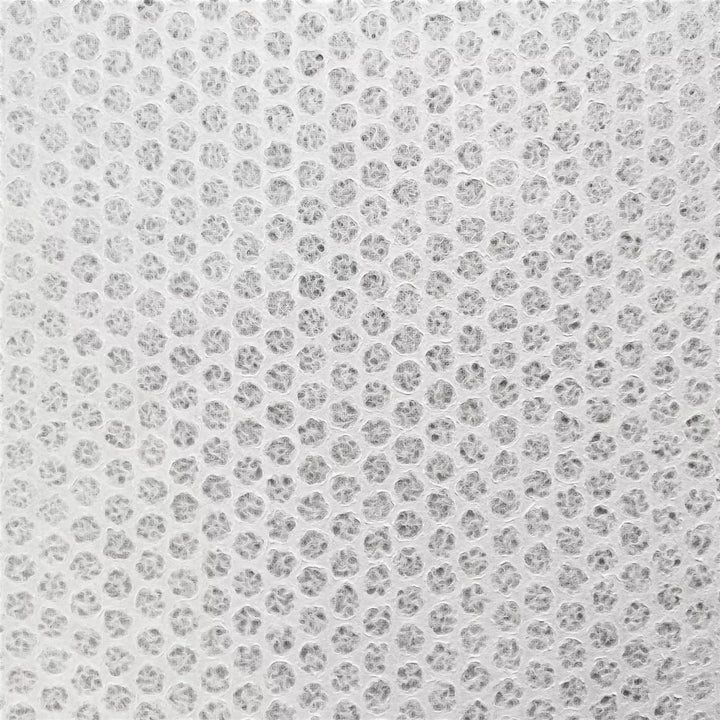Frame-made handmade paper with unique water-displaced patterns, featuring lace-like polkadot textures from Kozo Studio's mulberry paper collection.