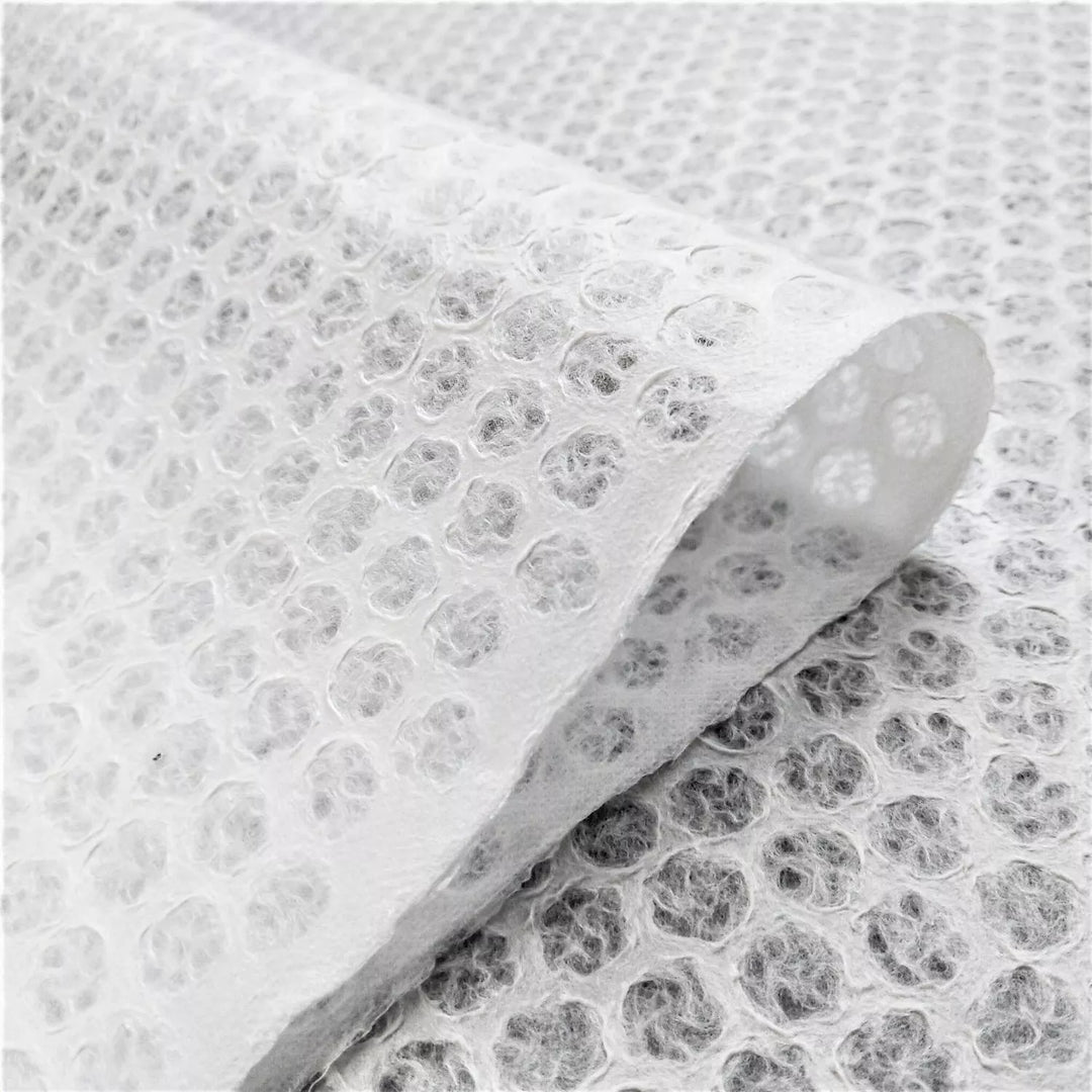Elegant handmade mulberry paper with a polkadot lace motif, crafted by Kozo Studio using traditional Rakusui techniques.