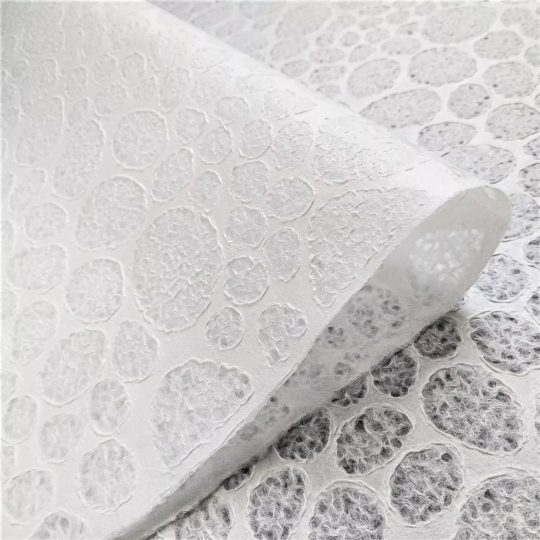 Handmade paper featuring a stone pattern lace effect, created at Kozo Studio from mulberry pulp through Rakusui, used in lighting and paper crafts.