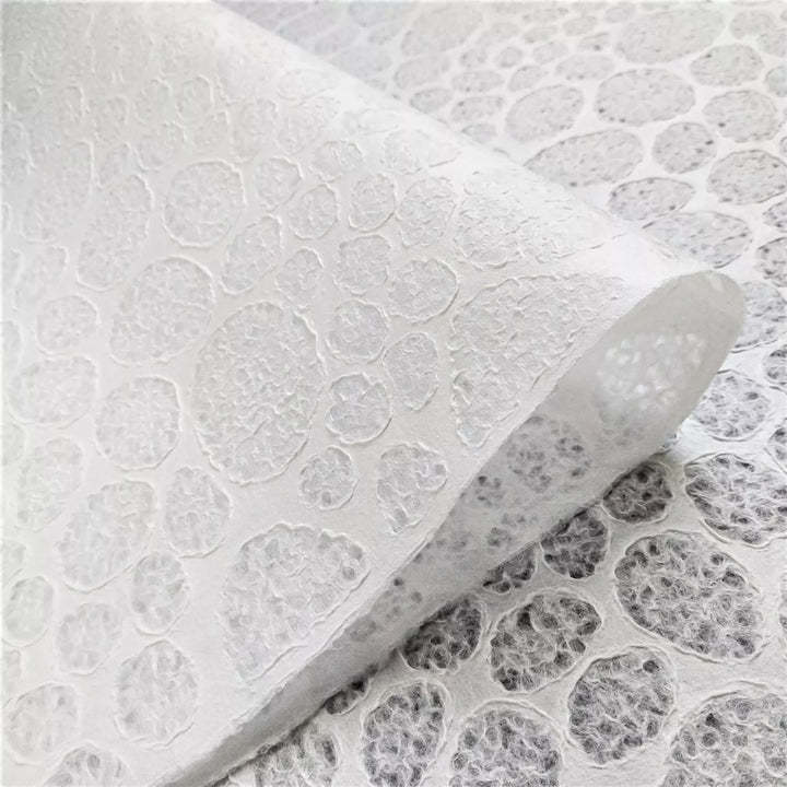 Handmade paper featuring a stone pattern lace effect, created at Kozo Studio from mulberry pulp through Rakusui, used in lighting and paper crafts.