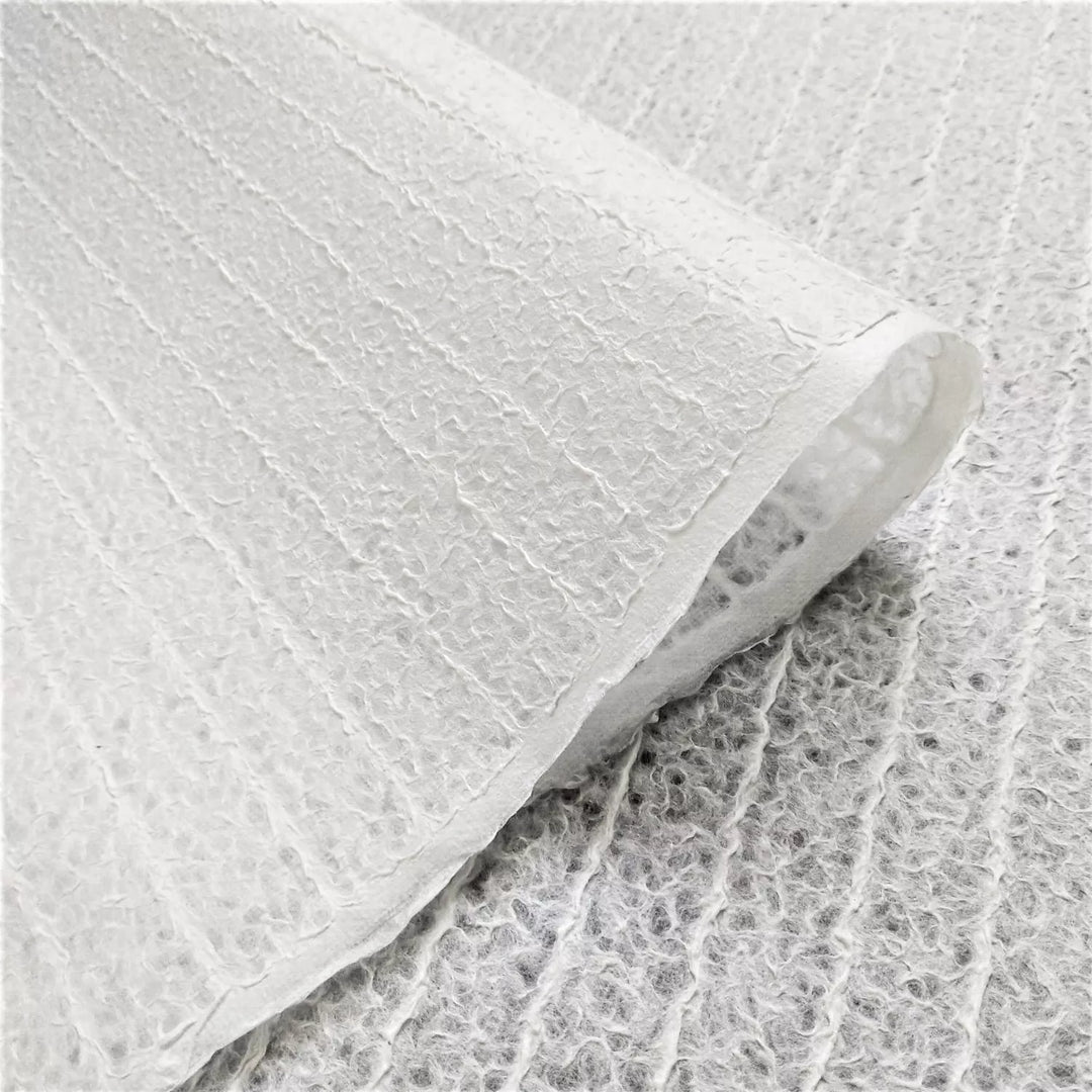 Fine detail of white handmade lace Kozo paper from Kozo Studio, highlighting the Rakusui-crafted design with its soft texture and light-filtering properties typical of high-quality mulberry paper.