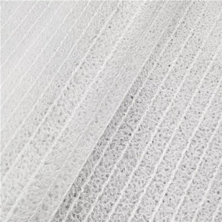 The Handmade Lace Kozo Paper (Stripe) from Kozo Studio features a textured white design with raised, fuzzy lines on a sheet of mulberry paper. Its soft surface and subtle shading evoke the delicate nature of rice paper.