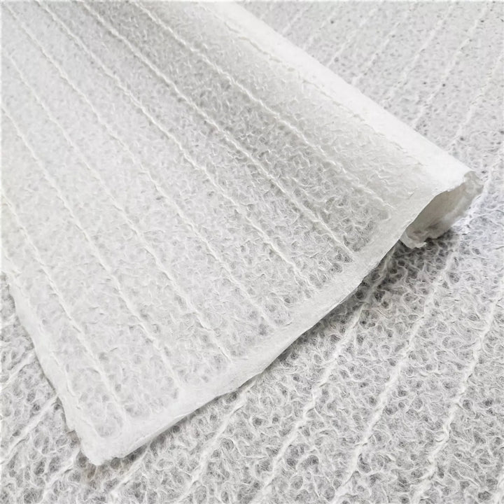 Close-up image of white stripe-patterned mulberry paper handcrafted by Kozo Studio using the Rakusui technique, showcasing the delicate texture and translucency of this premium handmade paper.