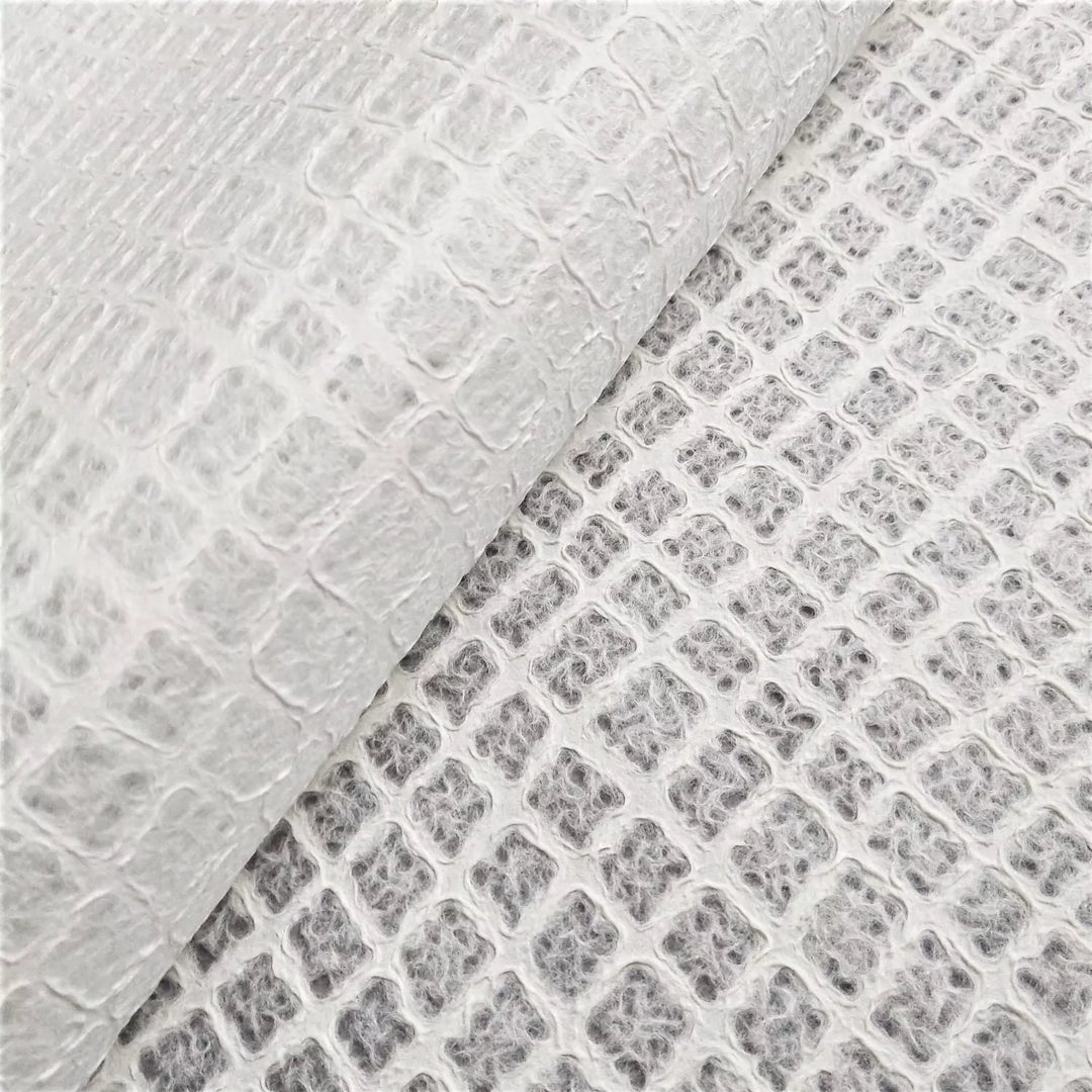 Artistic mulberry paper design from Kozo Studio, featuring a close-up of handmade paper with a light, airy texture ideal for decorative and functional crafts.