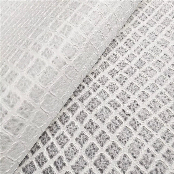 Artistic mulberry paper design from Kozo Studio, featuring a close-up of handmade paper with a light, airy texture ideal for decorative and functional crafts.