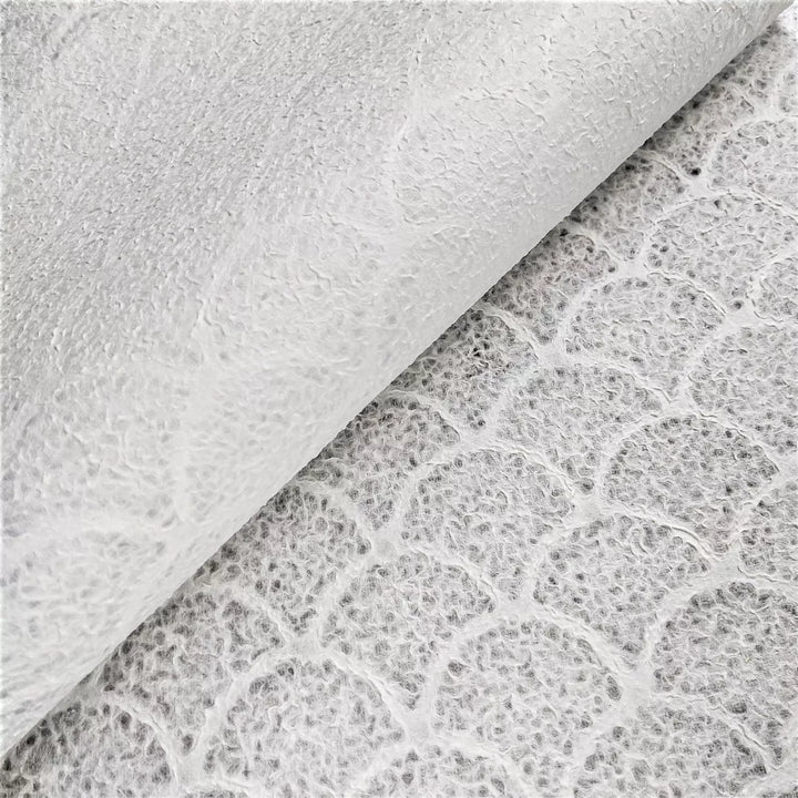 Kozo Studio lace paper in wave pattern, a refined piece of handmade mulberry paper used in decorative and functional design applications.