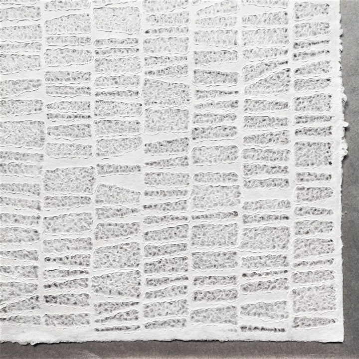 Kozo Studio handmade lace paper crafted from mulberry fibers, presenting a close-up of the Egyptian stone pattern with intersecting textured lines and natural fiber details.