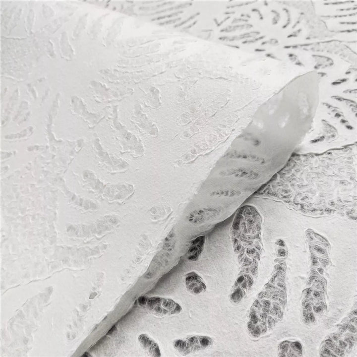 Translucent handmade mulberry paper by Kozo Studio, featuring an intricate Monstera leaf lace design, ideal for art installations, lampshades, and decorative use.