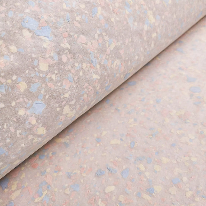Handmade paper by Kozo Studio featuring soft pastel flecks on a smooth mulberry paper base, ideal for creative crafts and artwork.