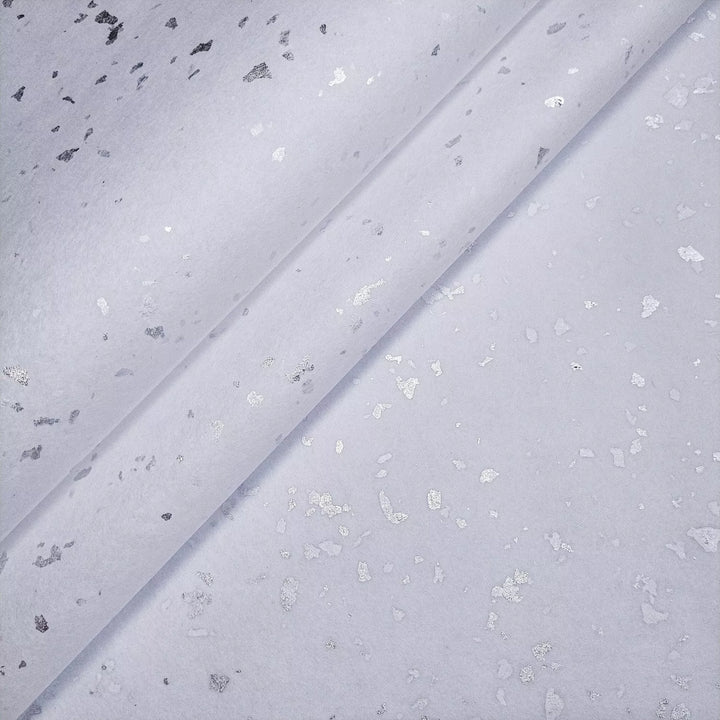 Elegant and delicate handmade mulberry paper featuring silver flakes, photographed in Kozo Studio to highlight its refined texture for artistic projects.