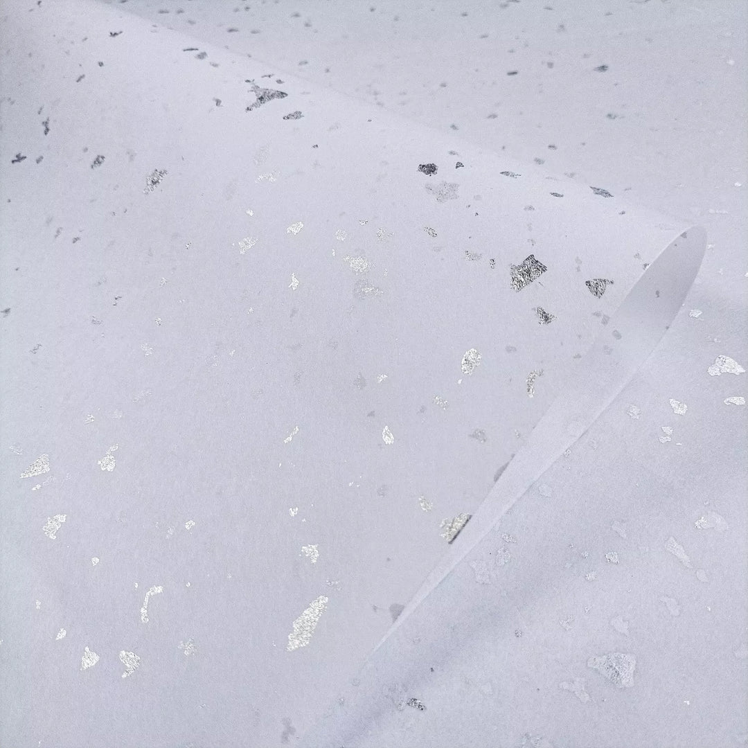 Minimalist mulberry paper with shimmering silver details captured in a Kozo Studio design, showcasing the beauty of high-quality handmade paper.