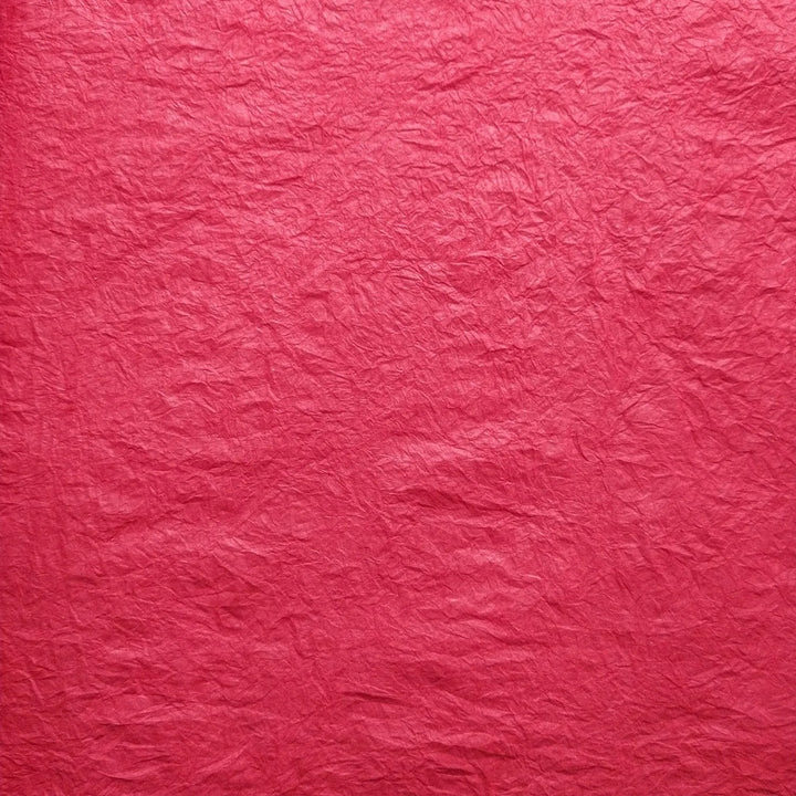 Handmade Momigami paper in vibrant red, made from mulberry fiber at Kozo Studio, showcasing its unique kneaded texture perfect for lampshades and decor.