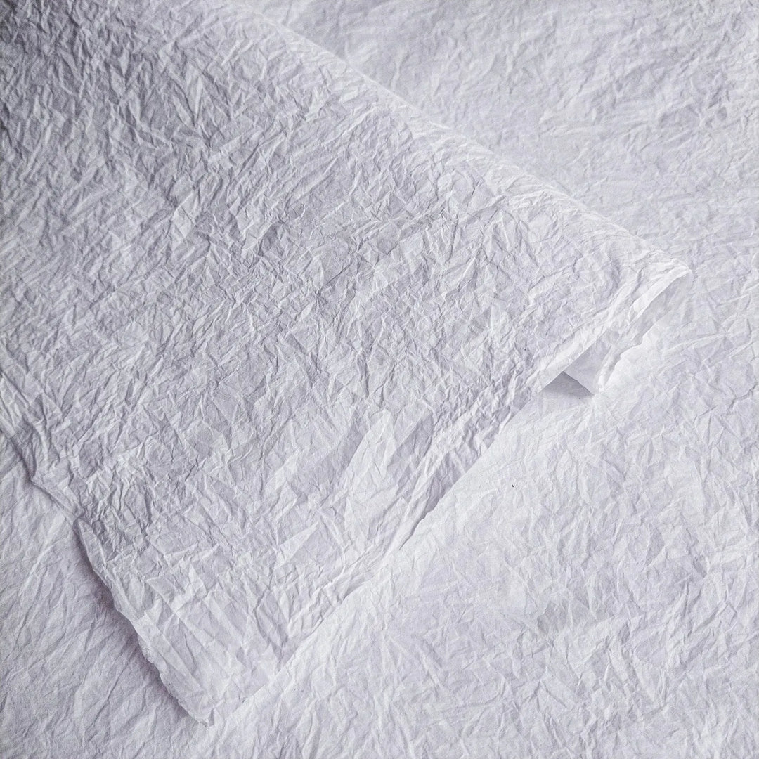 Close-up of crumpled white Momigami mulberry paper by Kozo Studio, highlighting its unique handmade texture for creative uses.