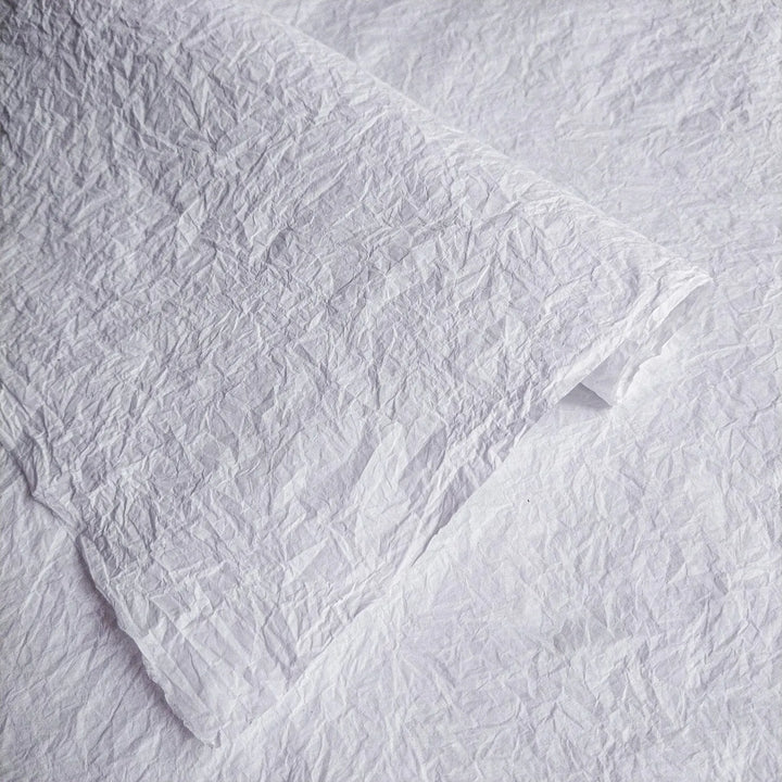 Close-up of crumpled white Momigami mulberry paper by Kozo Studio, highlighting its unique handmade texture for creative uses.