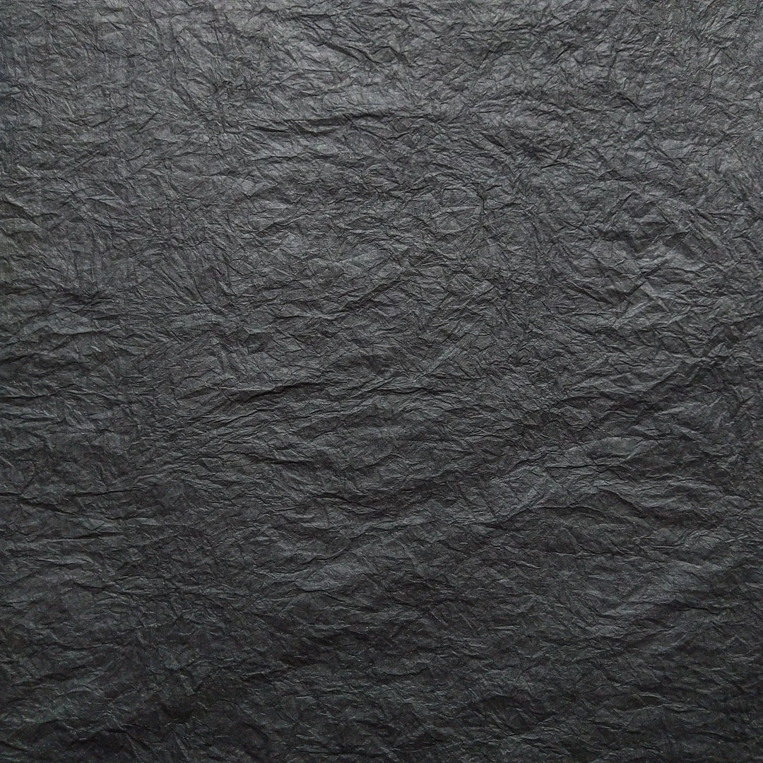 Detailed image of Momigami mulberry paper in black, a handmade paper from Kozo Studio known for its unique tactile texture and versatile use in creative projects.