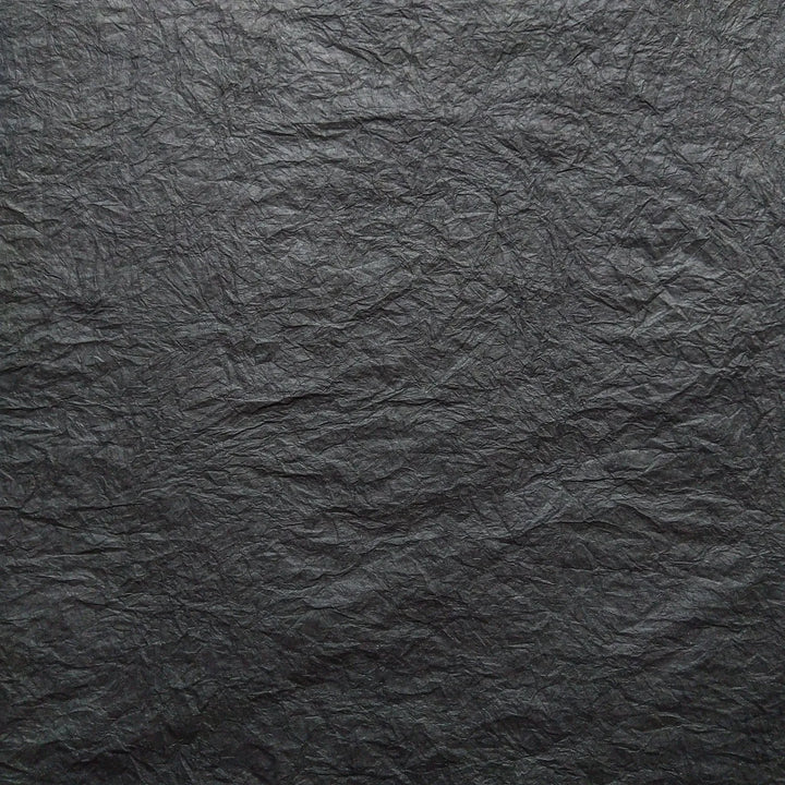 Detailed image of Momigami mulberry paper in black, a handmade paper from Kozo Studio known for its unique tactile texture and versatile use in creative projects.