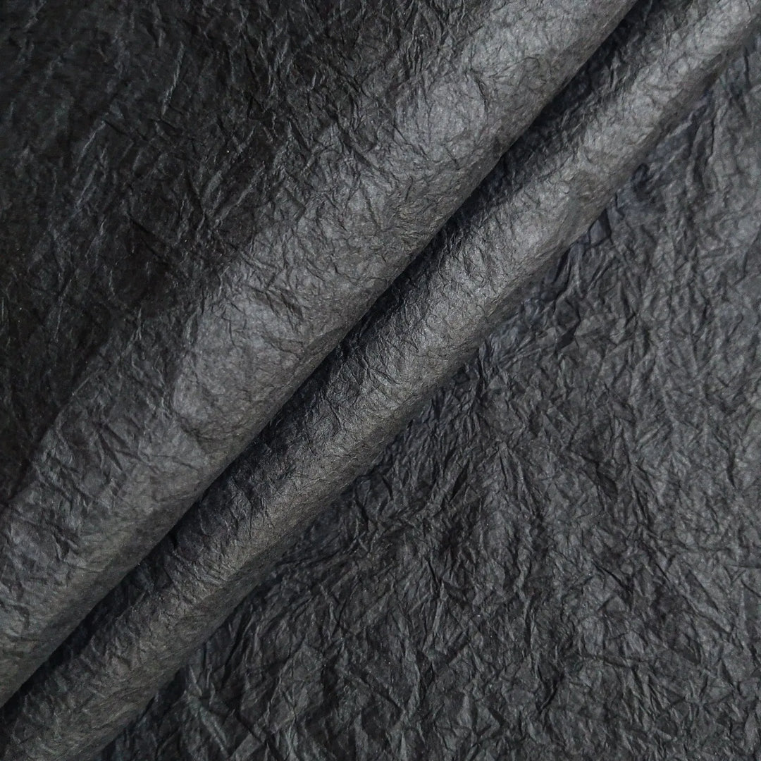 Black Momigami paper from Kozo Studio photographed in detail, a type of handmade mulberry paper appreciated for its softness, strength, and artistic potential.