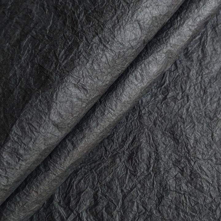 Black Momigami paper from Kozo Studio photographed in detail, a type of handmade mulberry paper appreciated for its softness, strength, and artistic potential.