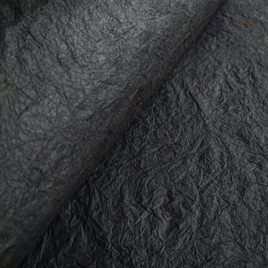 Texture-rich close-up of handmade Momigami mulberry paper from Kozo Studio, highlighting its flexible surface and suitability for craft, gift wrap, and design use.