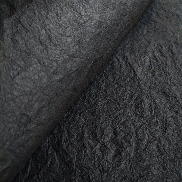 Texture-rich close-up of handmade Momigami mulberry paper from Kozo Studio, highlighting its flexible surface and suitability for craft, gift wrap, and design use.