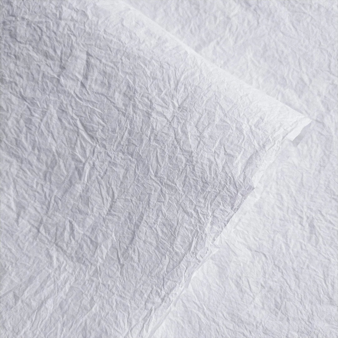 Textured white Momigami mulberry paper from Kozo Studio, showcasing its crumpled handmade surface ideal for bookbinding and crafts.