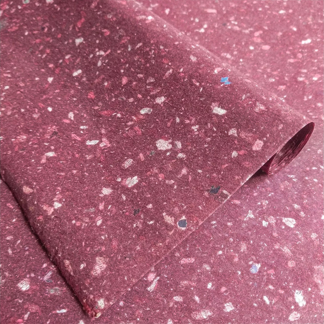 Handmade mulberry paper with speckled texture created by tiny bits of newspaper layered over kozo pulp at Kozo Studio. Smooth and flexible, ideal for eco-friendly art and craft projects.