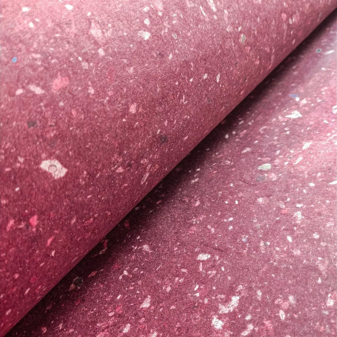 Kozo Studio's mulberry paper made from kozo pulp and scattered newspaper pieces. This handmade paper offers a soft, smooth surface perfect for artistic and crafting uses.