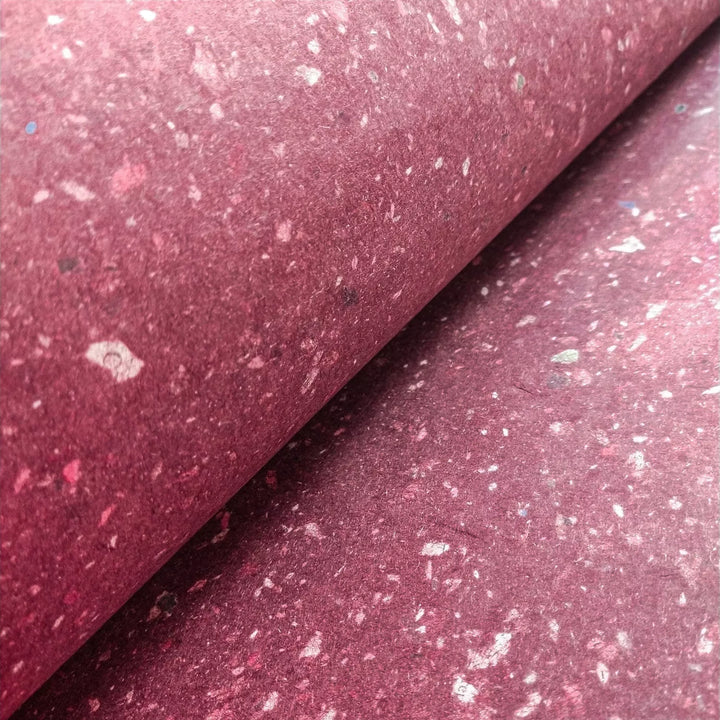 Kozo Studio's mulberry paper made from kozo pulp and scattered newspaper pieces. This handmade paper offers a soft, smooth surface perfect for artistic and crafting uses.