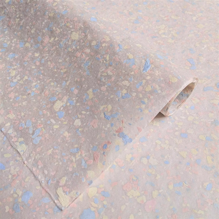 Speckled mulberry paper crafted at Kozo Studio using creamy kozo pulp and pastel bond paper accents, perfect for handmade paper art projects.