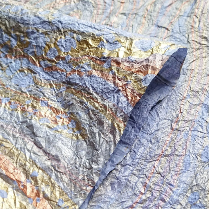 Unique handmade kozo paper in light blue with oil-based marbling, showcasing the refined craftsmanship of Kozo Studio's mulberry paper collection.