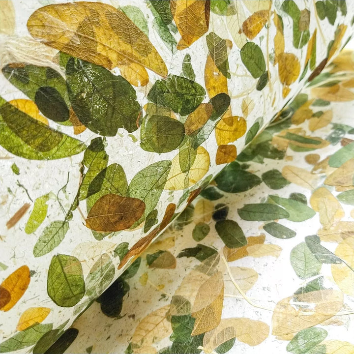 Artistic mulberry paper enriched with natural Raintree leaf details, designed by Kozo Studio as a premium handmade paper for creative projects.