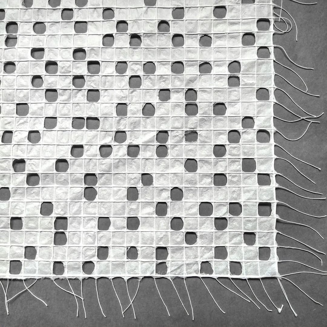 Detailed image of white kozo paper from Kozo Studio, highlighting the hand-drawn thread pattern on this elegant handmade mulberry paper.