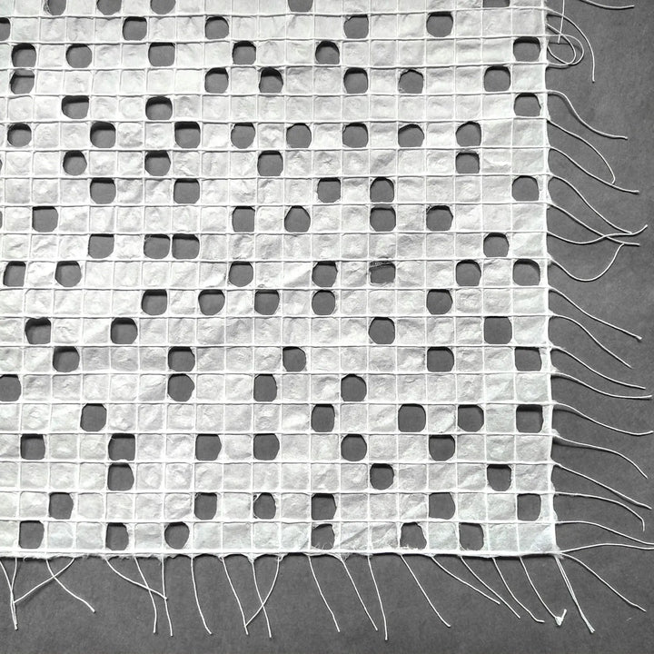 Detailed image of white kozo paper from Kozo Studio, highlighting the hand-drawn thread pattern on this elegant handmade mulberry paper.