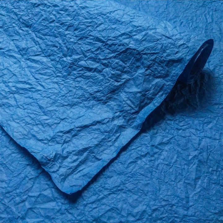 Textured blue Momigami handmade paper by Kozo Studio, crafted with mulberry fibers and starch for use in lampshades, gift wrap, and more.