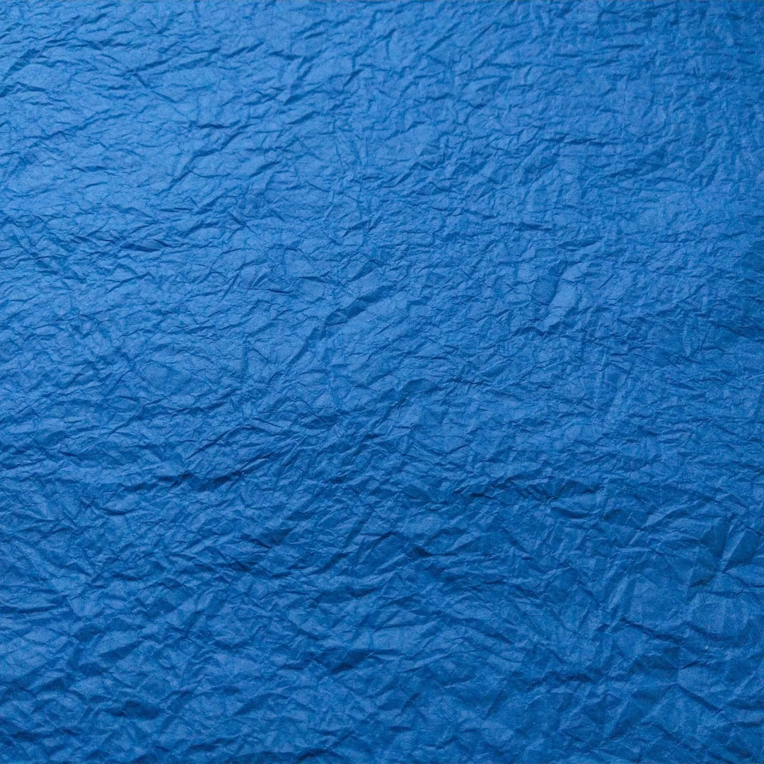 Handmade blue Momigami paper made from mulberry fibers, showcasing a unique texture perfect for bookbinding and decorative arts from Kozo Studio.